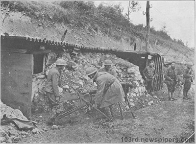 Men of the regiment 
bringing machine guns of the enemy out of the dugouts in which the Boche had
concealed arms and ammunitions near St Remy, September 13, 1918
